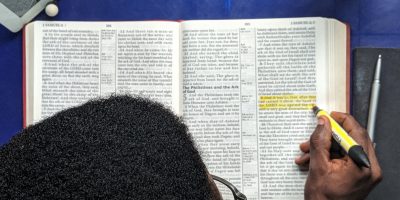 top-view-photo-of-man-reading-a-book-2574619