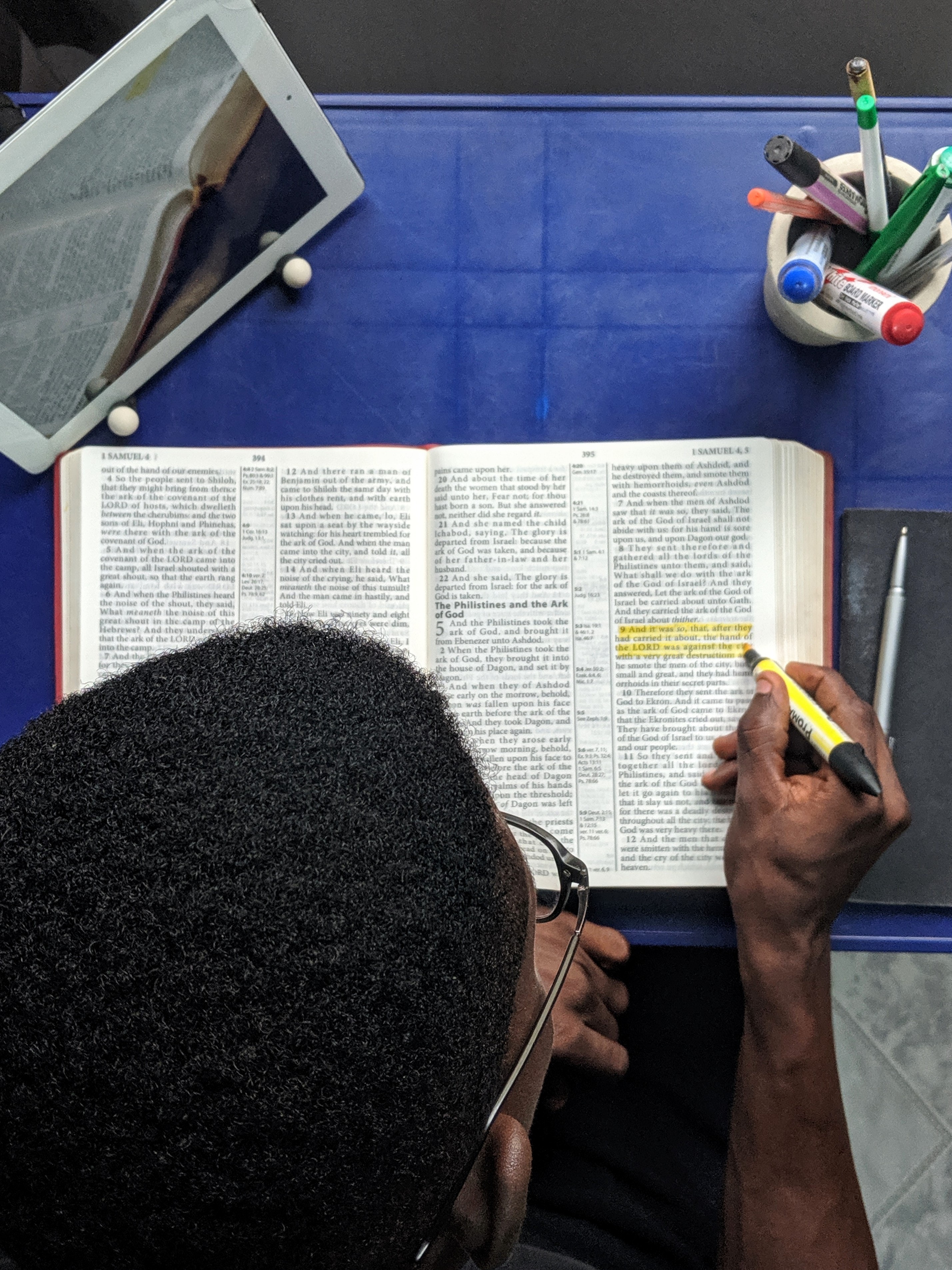 top-view-photo-of-man-reading-a-book-2574619